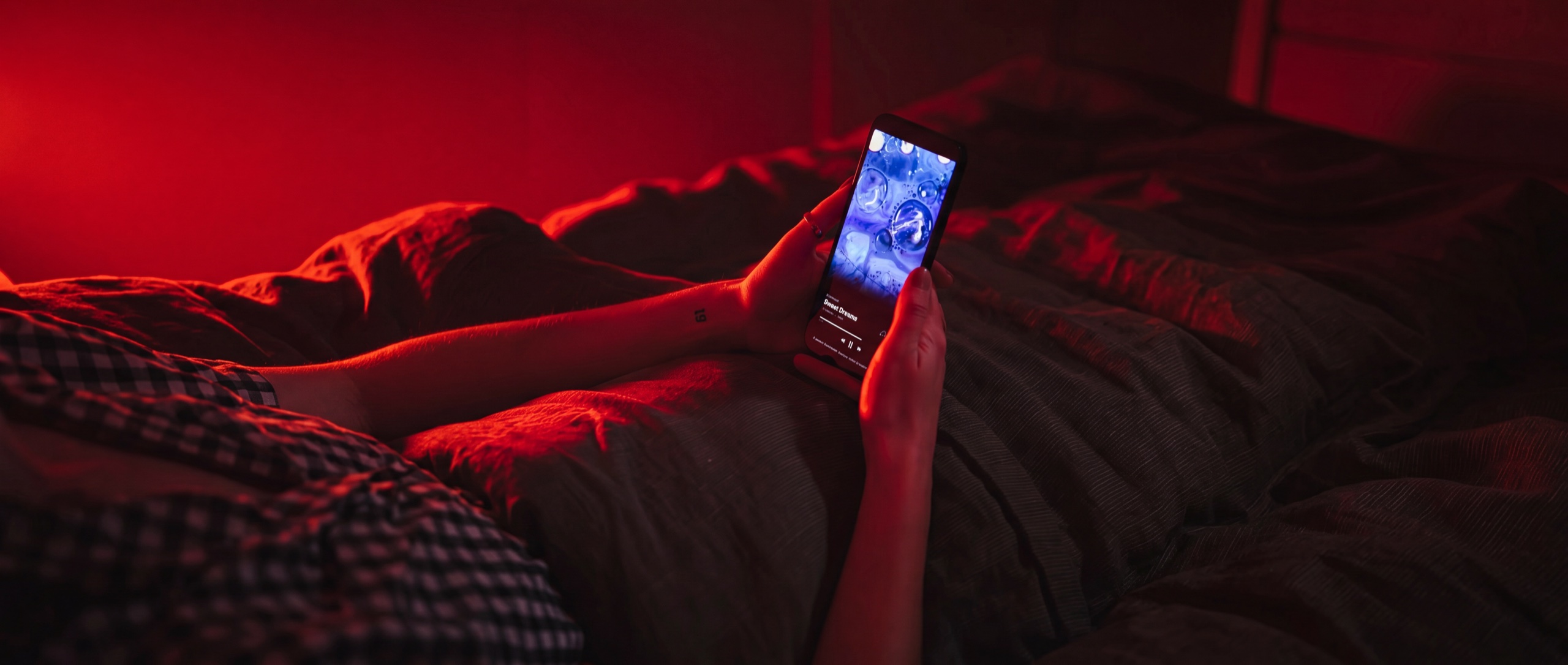 A person resting with The Breath Haus app glowing in their hands